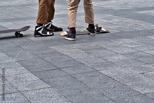 teenagers and overturned skateboard