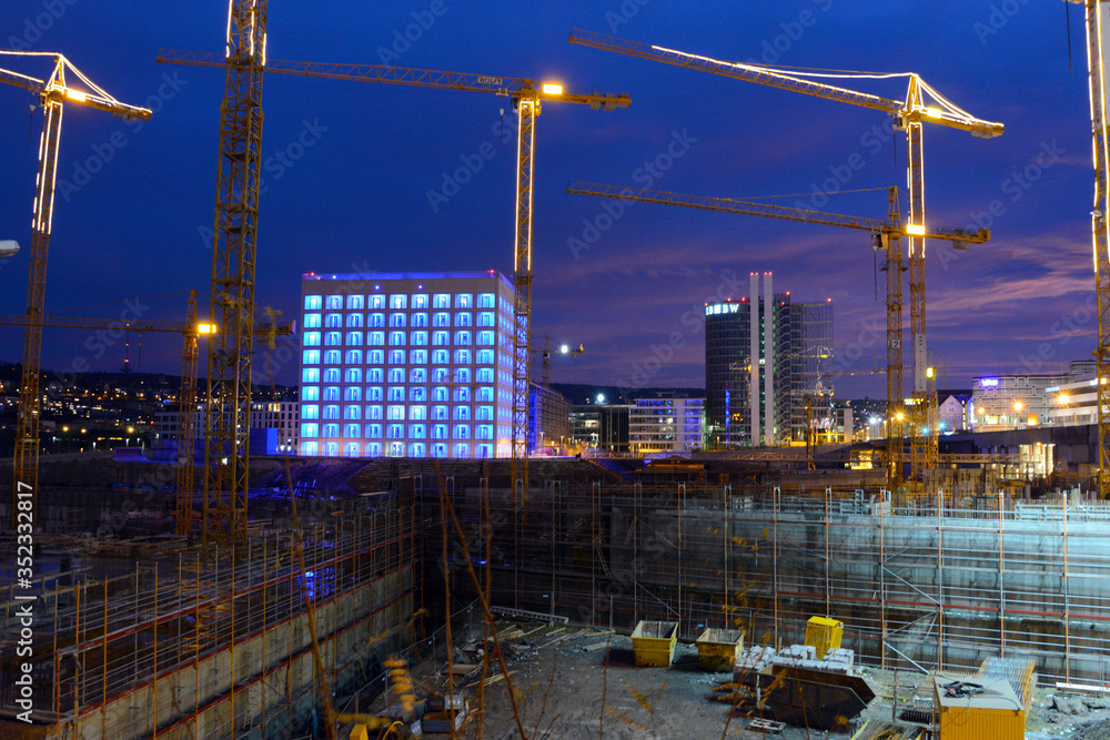 illuminated Stuttgart 21 construction site with library at dusk
