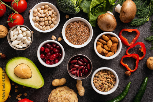 Vegan and healthy eating concept. Cereals and vegetables on a black background. Top view.
