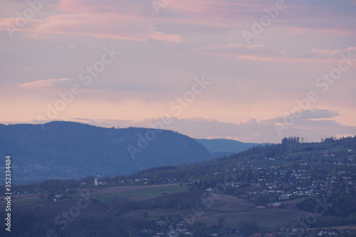 Landscape with city suburbs after sunset.