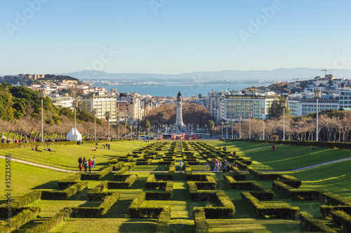 View of Parque Eduardo VII in Lisbon, Portugal, on a beautiful winter sunny day, with castle on the left and the Tejo river and Arrabida mountains in background photo