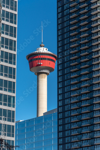View of the Calgary skyline with modern buildings and the Calgary Tower. 