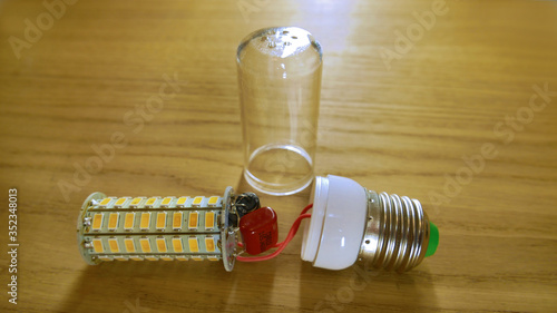 disassembled LED lamp similar to corn with a plastic protective glass.