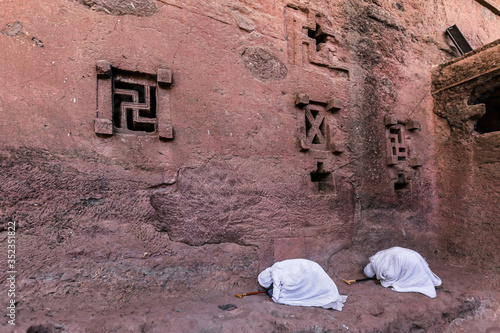 Piligrims at lalibela church stone wall photo