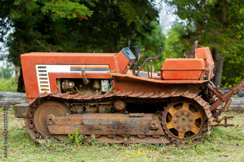 Abandoned and rusty tractor in rural Guatemala mountain, part of sawmill equipment.