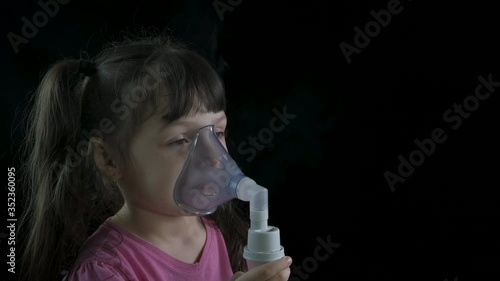 Cure child bronchitis. Little girl in a nebulizer mask.