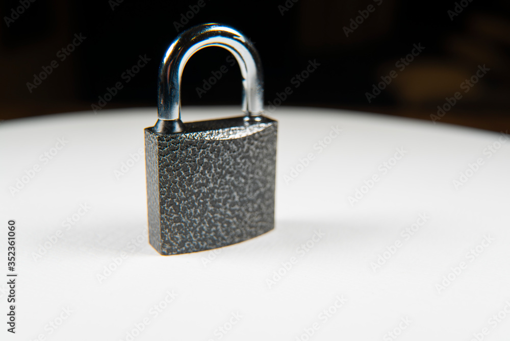 Locked black metal padlock on the white background. Locked black metal padlock on the white background.