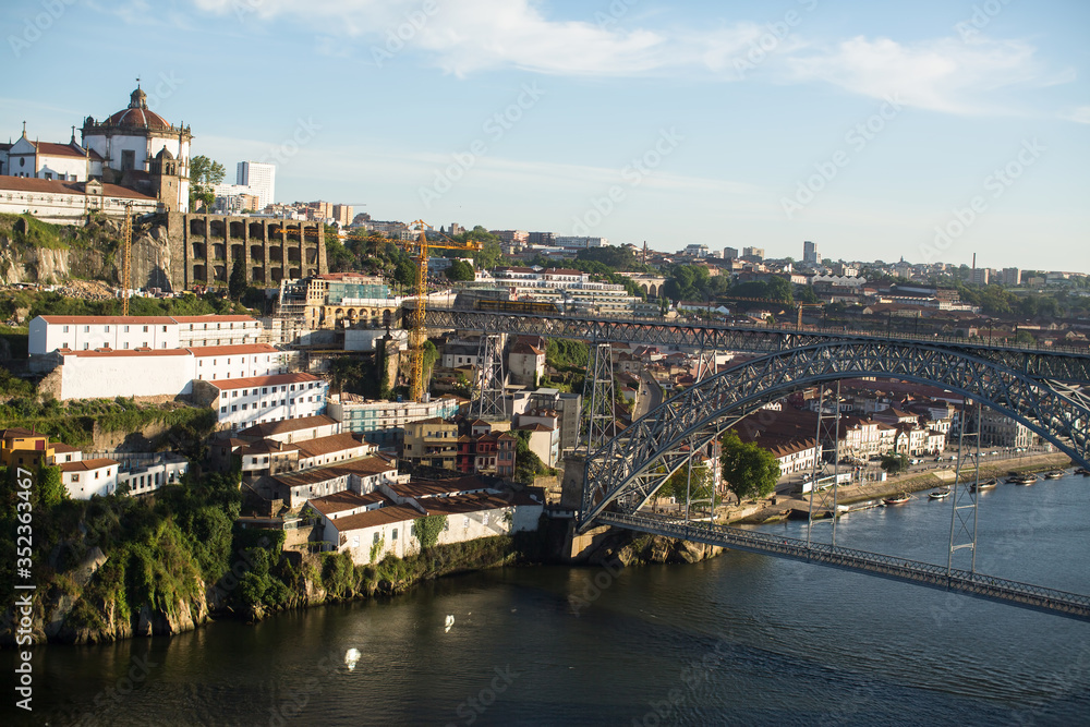 Fototapeta premium View of the Dom Luis I Bridge over the Douro river and the Bank of Vila Nova de Gaia, Porto, Portugal. .