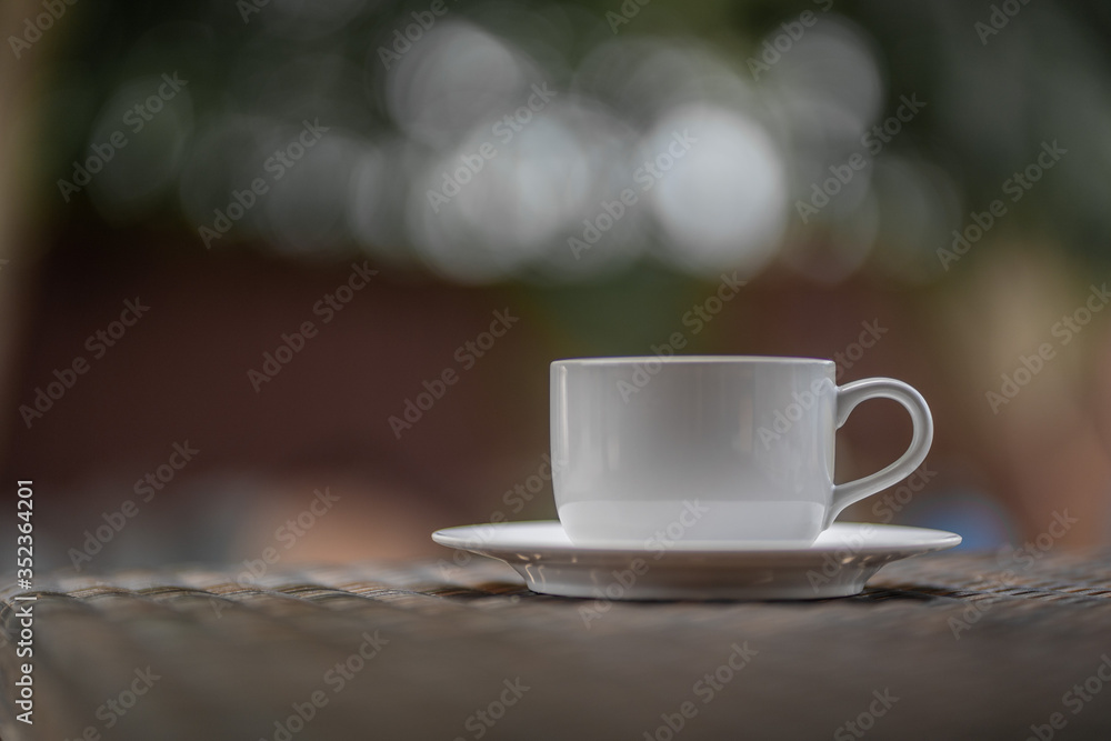 
A cup of coffee resting on a wooden table