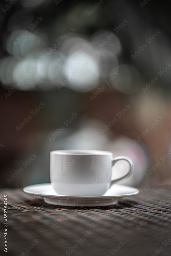 
A cup of coffee resting on a wooden table