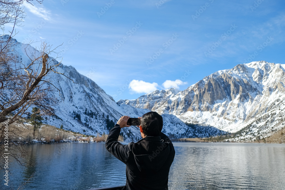 travel man use smart phone o taking photo of the beautiful mountain landscape. travel man use smart phone o taking photo of the beautiful mountain landscape.