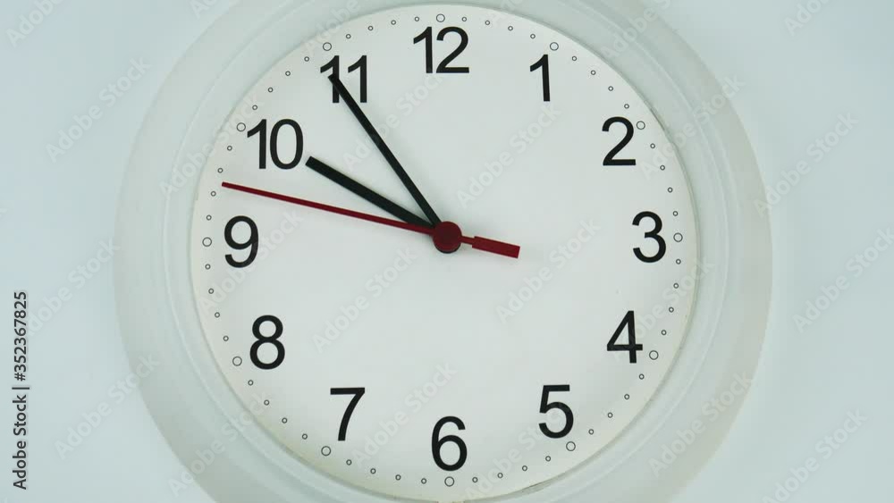 Close up White wall clock isolated on white background, face beginning of time 09.54 am or pm, Clock minute walk slowly, Time concept. Close up White wall clock isolated on white background, face beginning of time 09.54 am or pm, Clock minute walk slowly, Time concept.