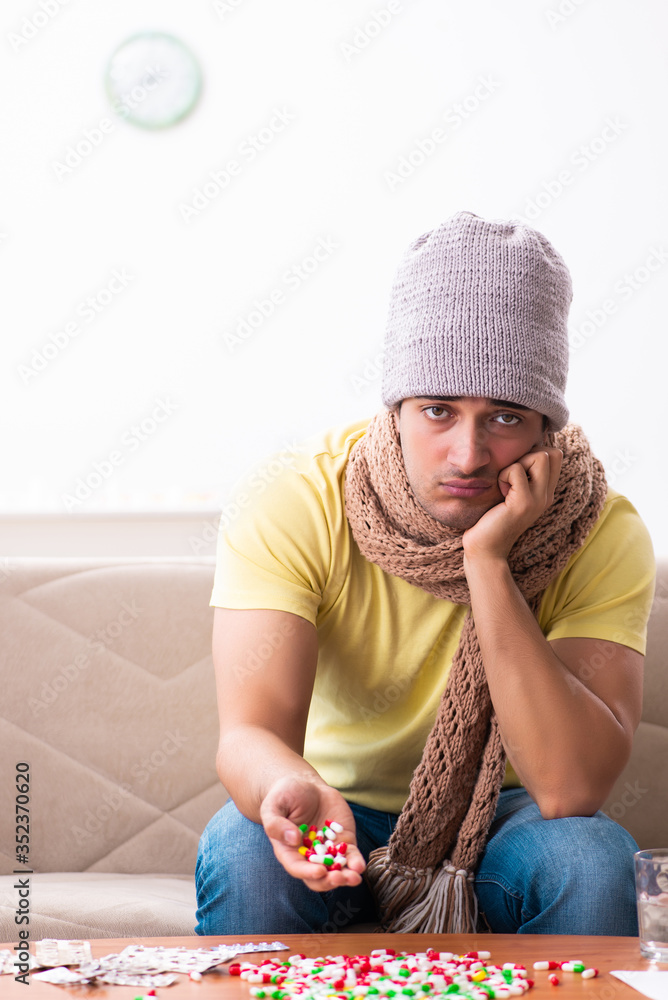 Fototapeta premium Young man suffering at home