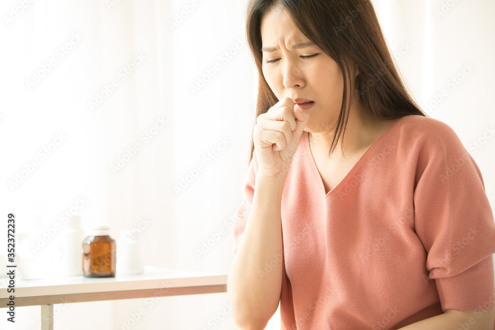 Woman at home sick and coughing, suffering asthma or bronchitis, medicine concept Woman at home sick and coughing, suffering asthma or bronchitis, medicine concept