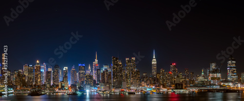 Wide panorama image of skyscrapers in Manhattan, New York at night