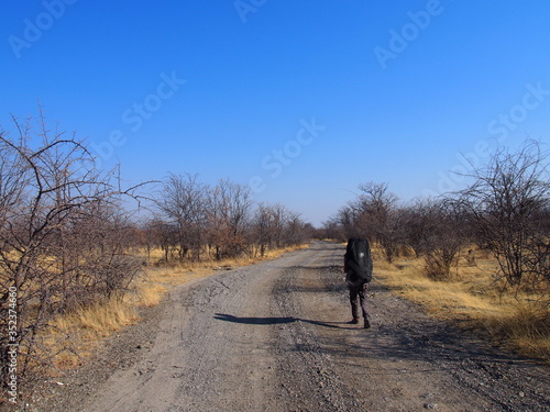 Woman walking from campsite to the main street, Planet Baobab, Botswana