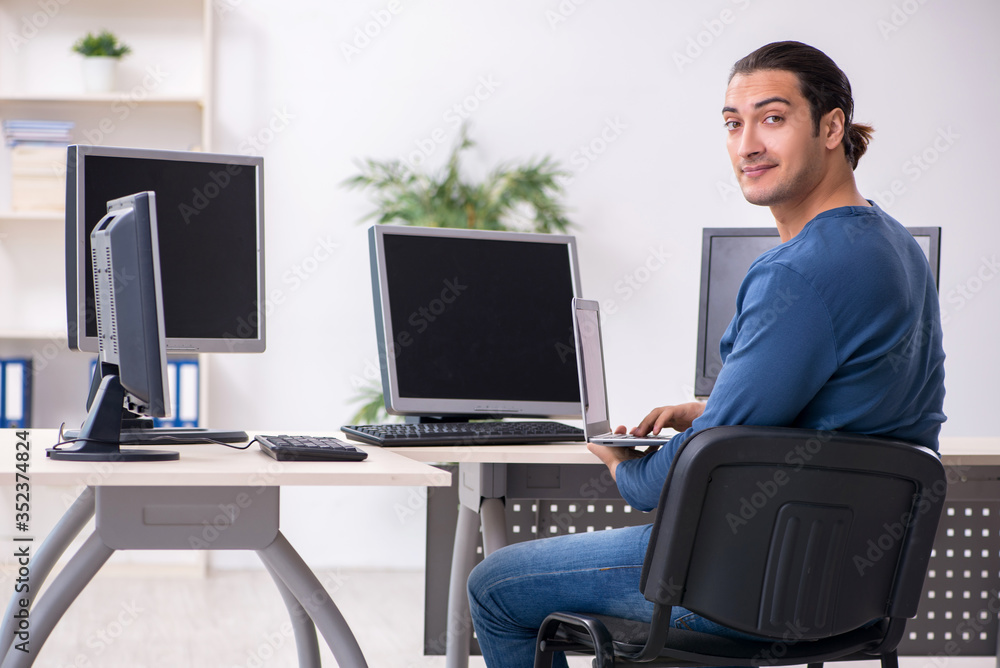 Young male it specialist working in the office Young male it specialist working in the office