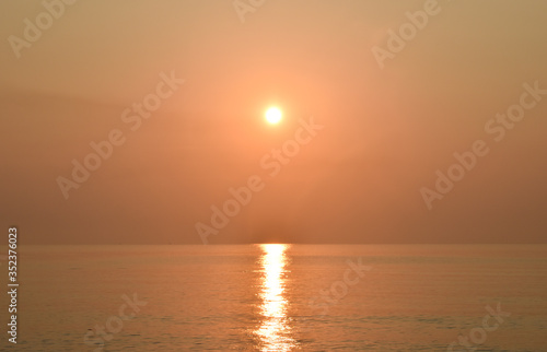 Sunrise and reflect on the sea. This picture is orange. © juthamas