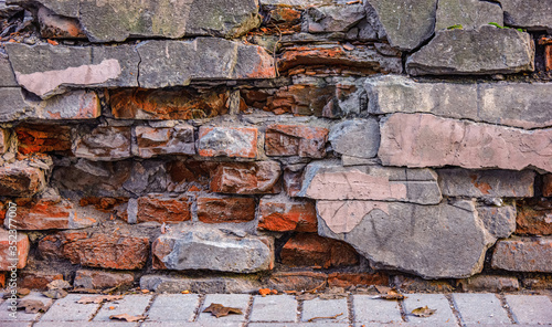 Old destructed brick wall on the street