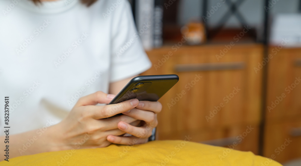 Closeup of young woman hand holding smartphone and chatting with friends at social network. Closeup of young woman hand holding smartphone and chatting with friends at social network.