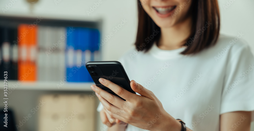 Closeup of young woman hand holding smartphone and chatting with friends at social network. Closeup of young woman hand holding smartphone and chatting with friends at social network.