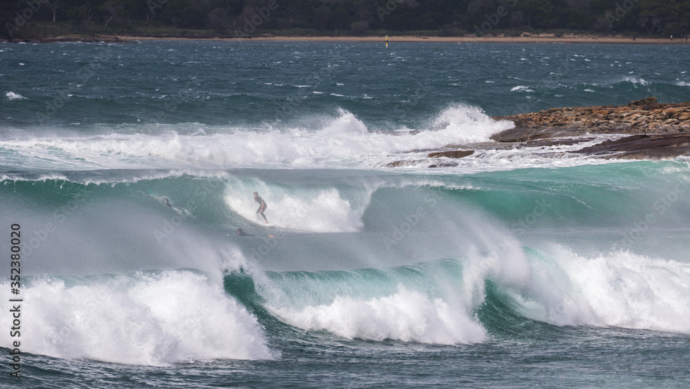 Fototapeta premium Surfing in large swell off a Sydney Beach
