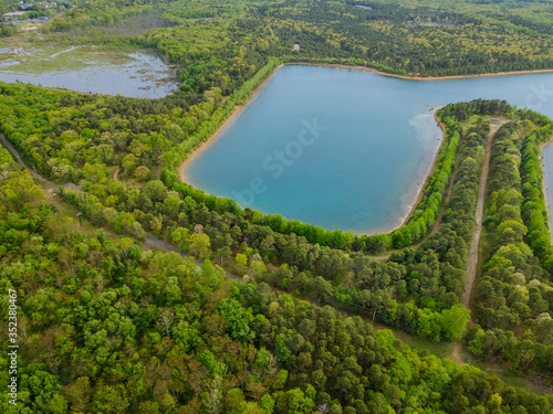 Aerial view of natural pond panorama of over trees forest
