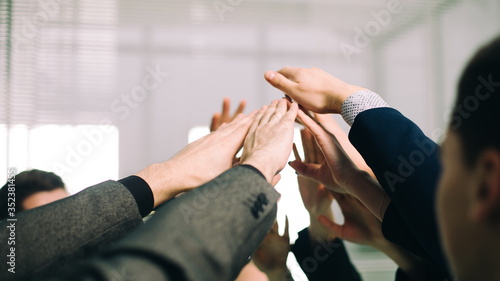 close up. a group of employees joining their palms