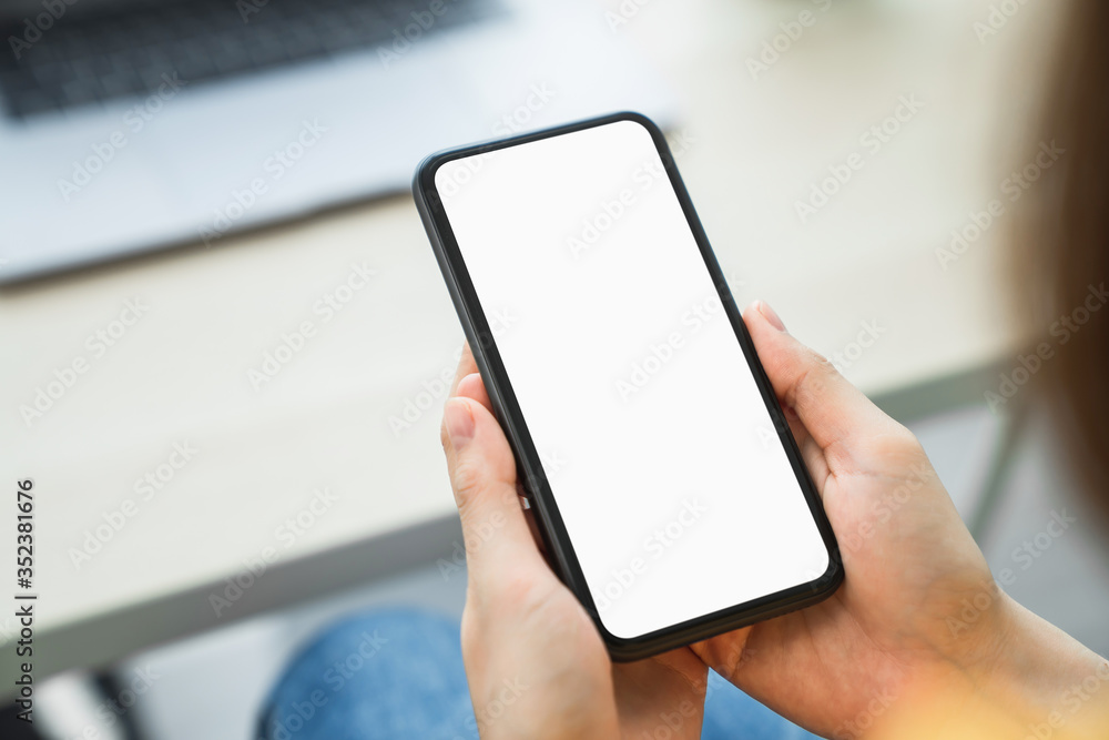Woman hand holding smartphone and touching blank screen. Mockup of advertisement. Woman hand holding smartphone and touching blank screen. Mockup of advertisement.