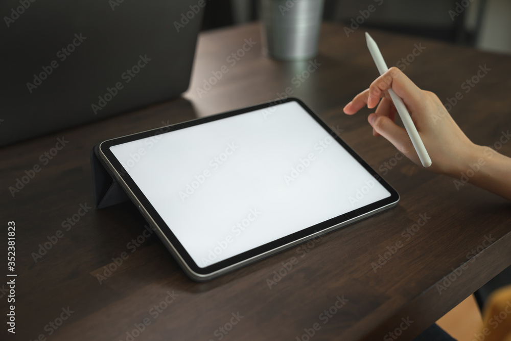 Mock up of woman hand holding digital tablet and touching blank screen. Mock up of woman hand holding digital tablet and touching blank screen.