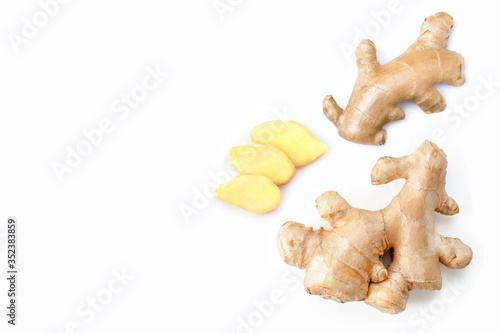 Closeup fresh organic ginger root with slice isolated on white background. Copyspace for text. Top view. Flat lay.