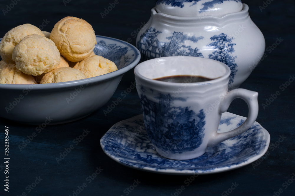 a cup of coffee with chipá, traditional paraguayan snack. a cup of coffee with chipá, traditional paraguayan snack.