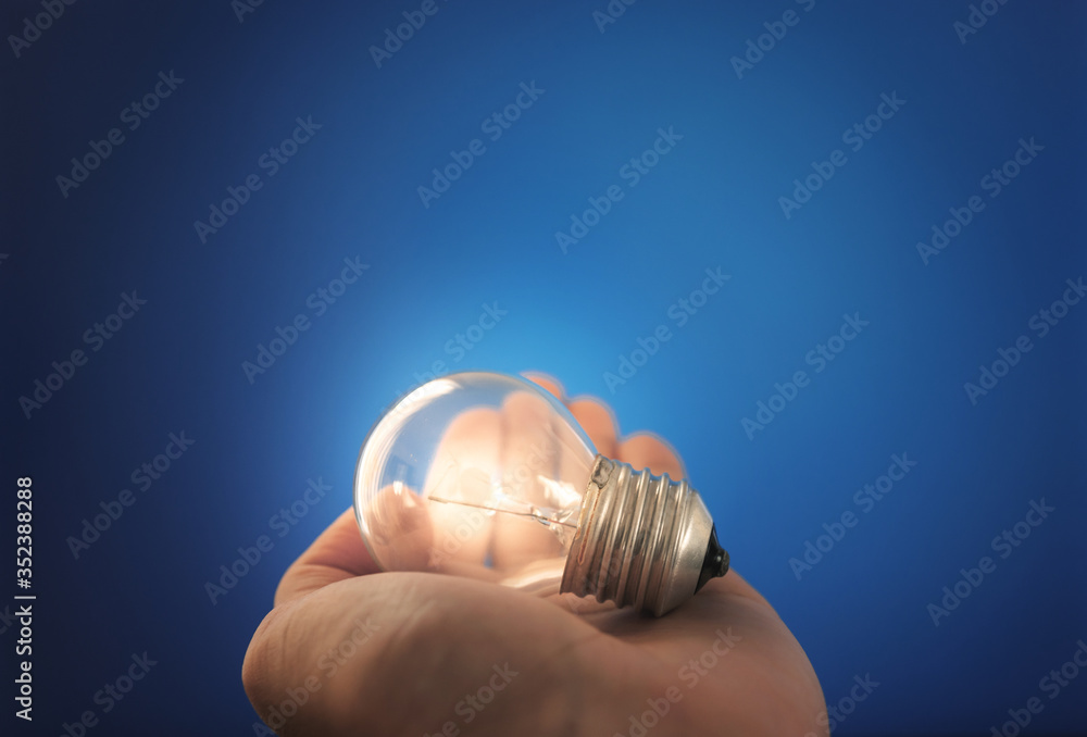 New ideas, innovation and inspiration concept. Glowing light bulb on hand New ideas, innovation and inspiration concept. Glowing light bulb on hand