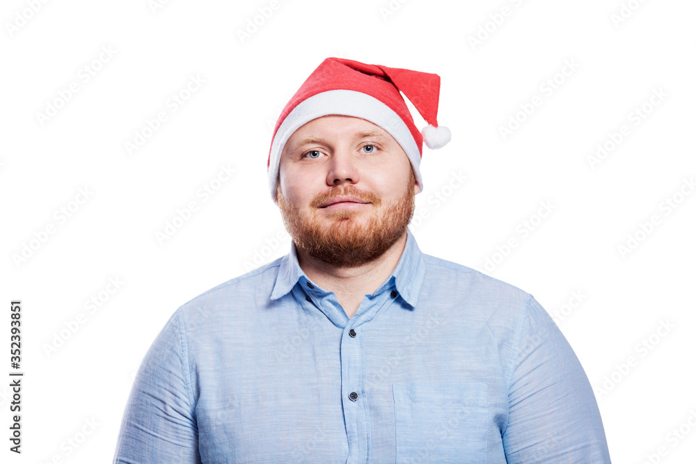 Smiling redhead man in santa claus hat. New Year and Christmas celebration. Isolated on a white background. Smiling redhead man in santa claus hat. New Year and Christmas celebration. Isolated on a white background.