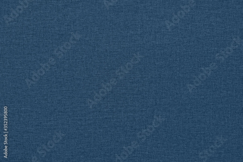 Dark blue background with a textured surface, fabric.