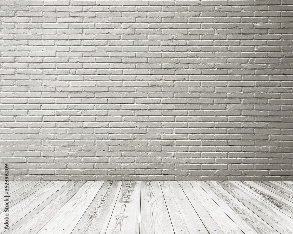 Fototapeta premium Pusta przestrzeń pokoju typu studio z białą ceglaną ścianą i drewnianą podłogą.