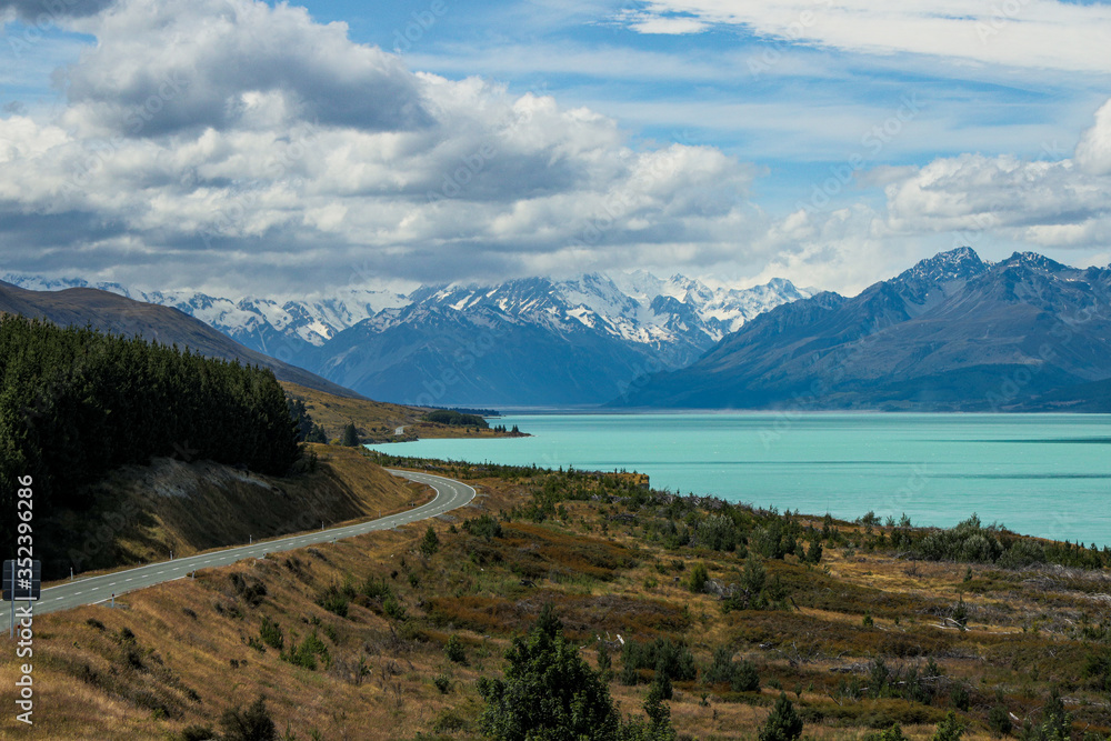Vibrant New Zealand lake with curving road