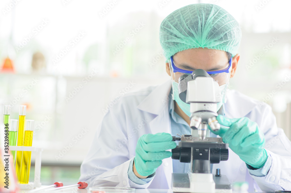 Scientists are looking at a microscopic to study and do research In order to produce therapeutic worms, corona virus drug research Scientists are looking at a microscopic to study and do research In order to produce therapeutic worms, corona virus drug research