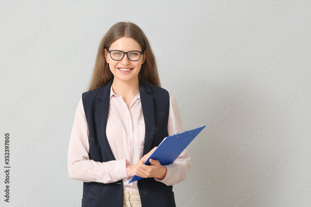 Beautiful young secretary on light background Beautiful young secretary on light background