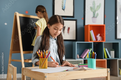 Cute girl drawing at school