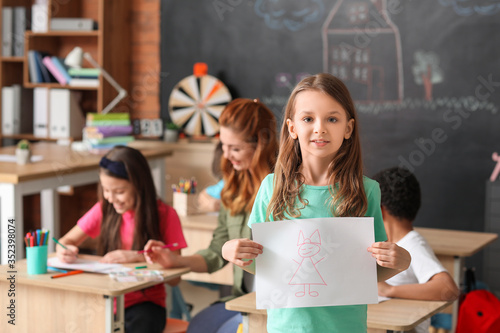 Cute girl with drawing at s...