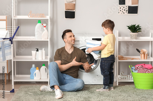 Man and his little son doin...