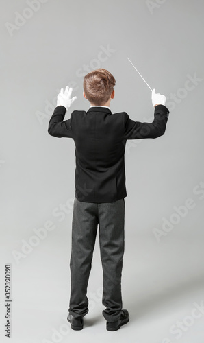 Little conductor on grey background photo