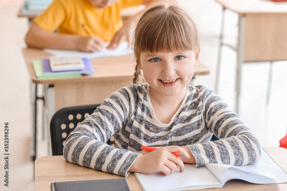 Little girl doing math task in classroom Little girl doing math task in classroom
