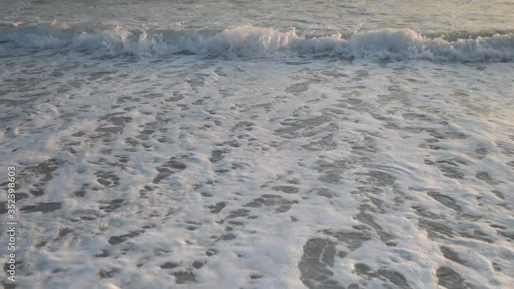 isolated waves breaking onto a sand beach isolated waves breaking onto a sand beach