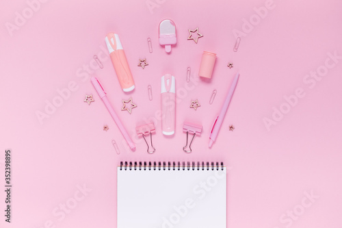 Back to school concept notepad, pencil case, stationery and school supplies. Top horizontal view copyspace pink background