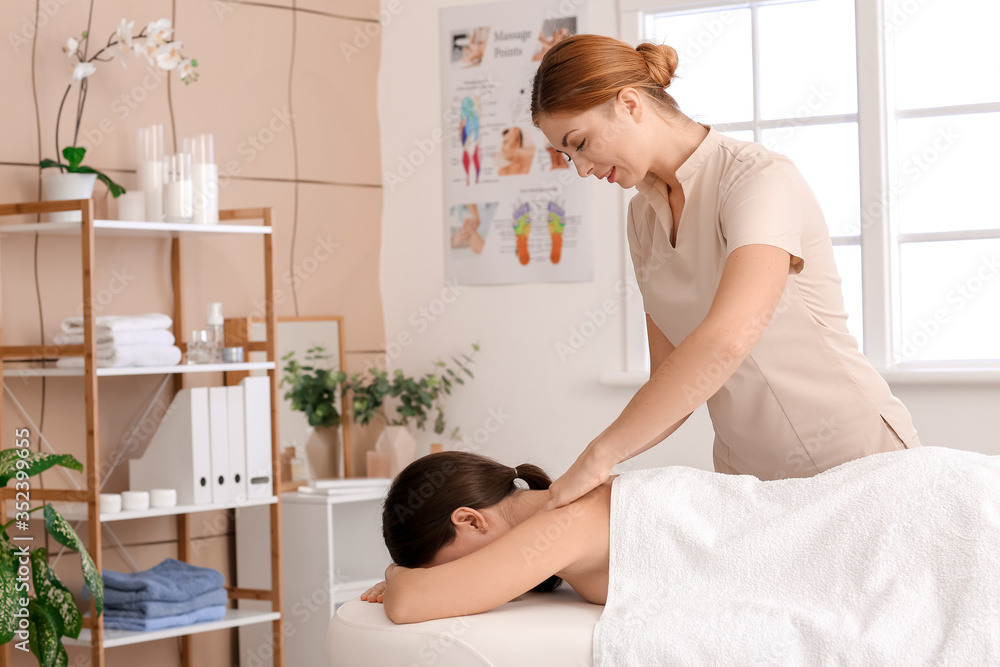 Massage therapist working with patient in medical center Massage therapist working with patient in medical center