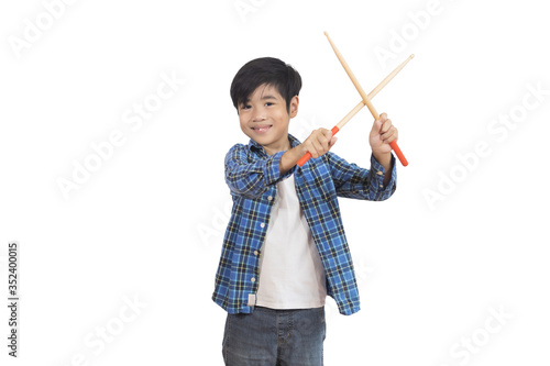 A portrait of a young Asian elementary school student wearing a plaid shirt and a drumstick. An isolated image with white background.
