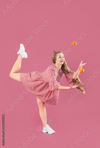 Young woman with tangerines...