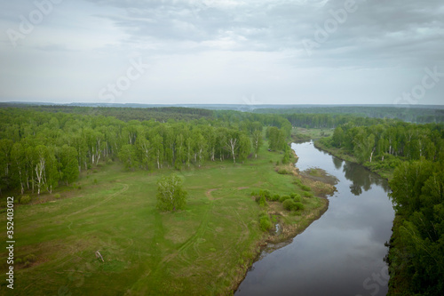 Morning in nature with a river  fields  trees. Aerial view.